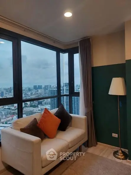 Stylish corner unit with panoramic city view and cozy seating area.