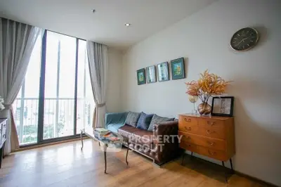 Stylish living room with large windows and elegant decor in modern apartment.