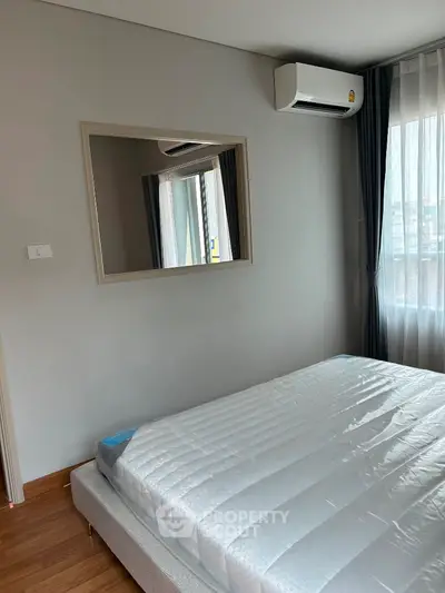 Modern bedroom with large window and air conditioning unit