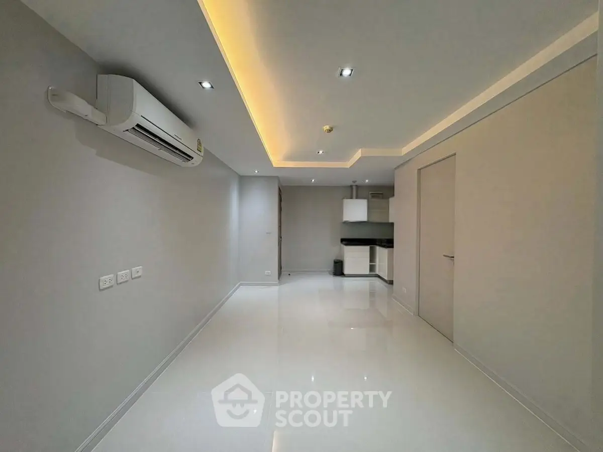 Modern minimalist interior with sleek lighting and air conditioning in a compact living space.