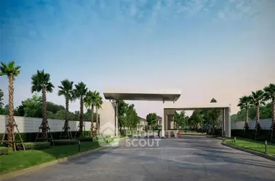 Luxurious gated community entrance with palm-lined driveway and modern architecture.