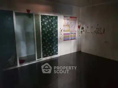 Spacious room with dark flooring and decorative sliding doors, ideal for creative interior design.