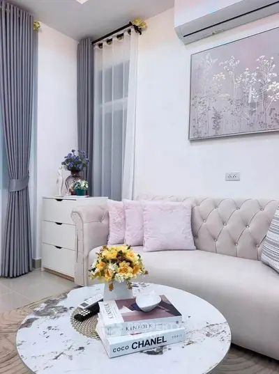 Elegant living room with plush sofa, chic decor, and stylish coffee table in modern apartment.