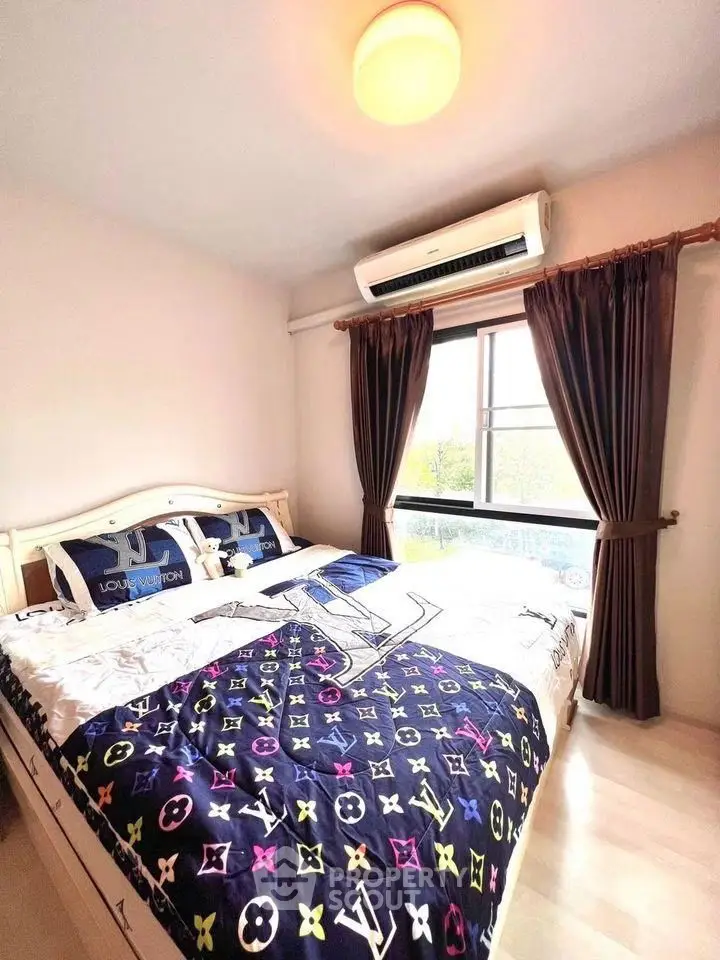 Cozy bedroom with stylish bedding and natural light from large window