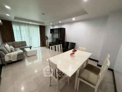 Spacious living and dining area with modern furniture and natural light