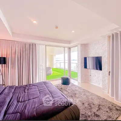 Luxurious bedroom with modern decor and spacious balcony offering stunning views.