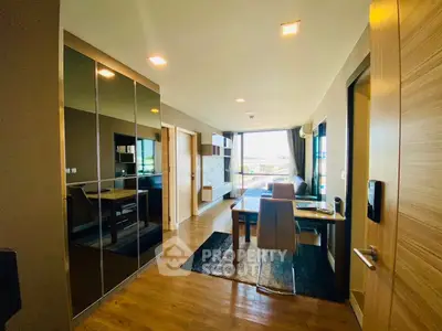 Modern living room with sleek furniture and large windows offering natural light.