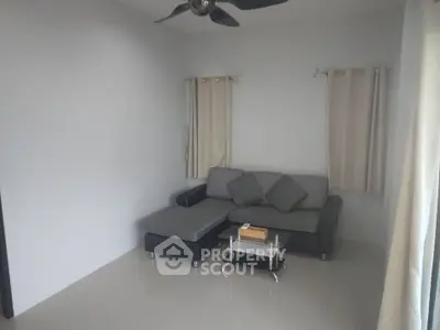 Cozy living room with modern sectional sofa and glass coffee table.