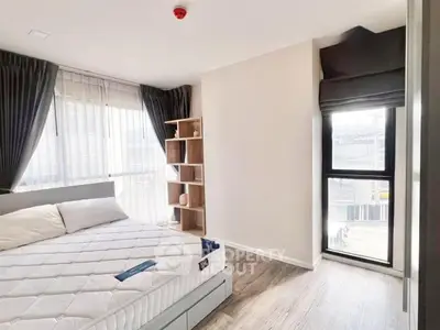 Bright and modern bedroom with large windows and stylish decor in a contemporary apartment.
