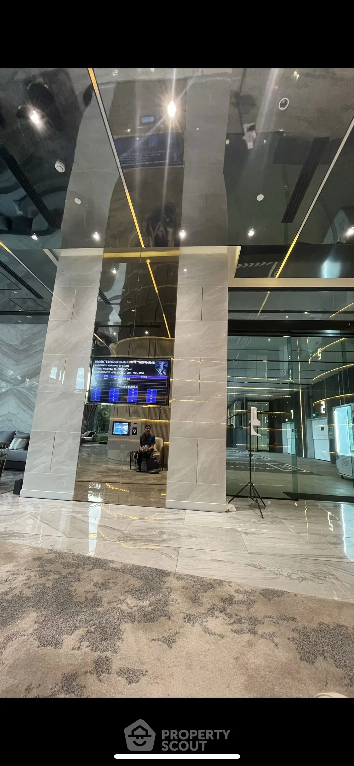 Luxurious modern building entrance with sleek marble and glass design
