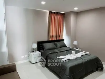 Cozy bedroom with elegant decor and natural light, perfect for relaxation and comfort.