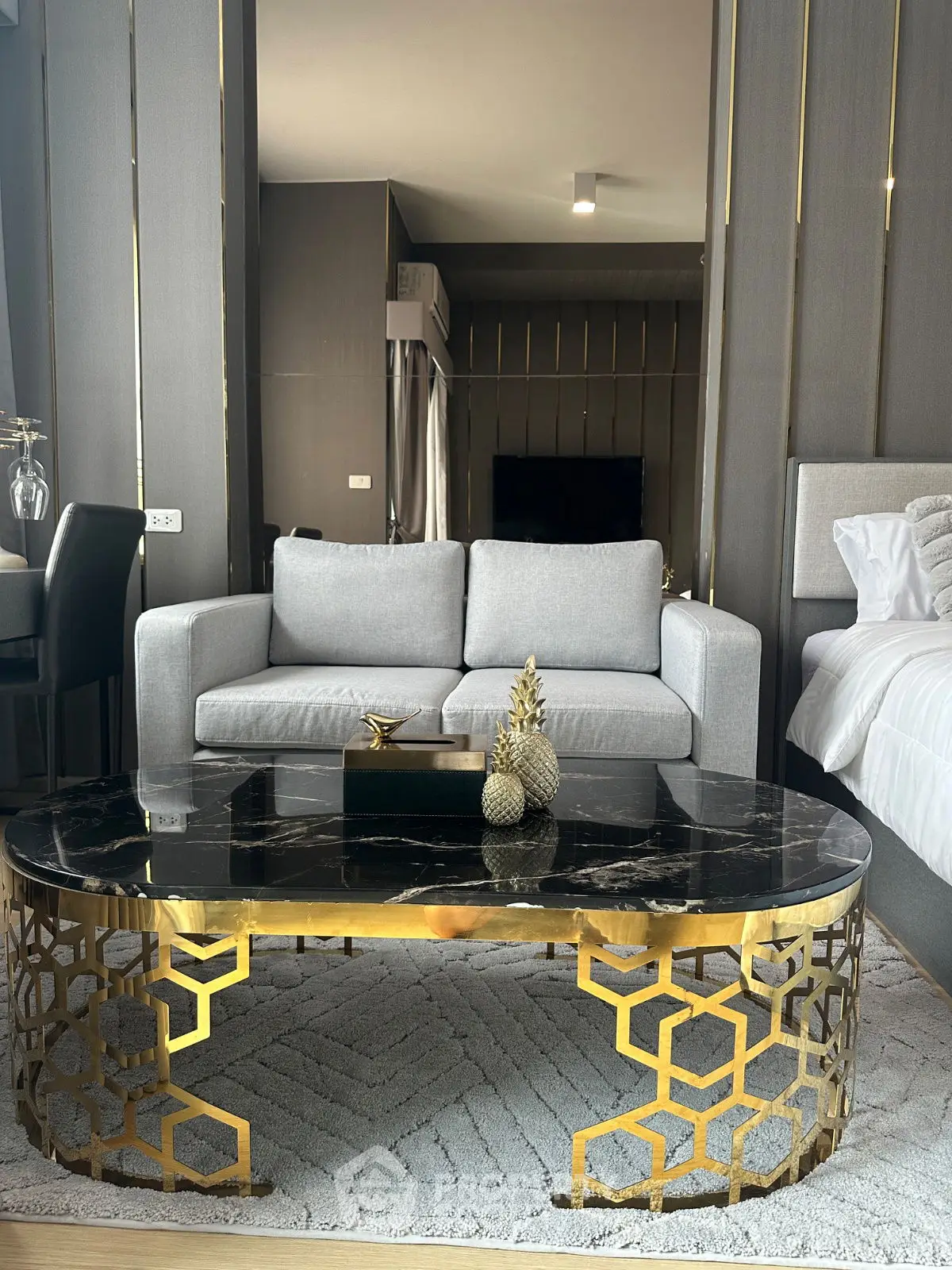 Luxurious modern living room with elegant gold-accented furniture and stylish decor