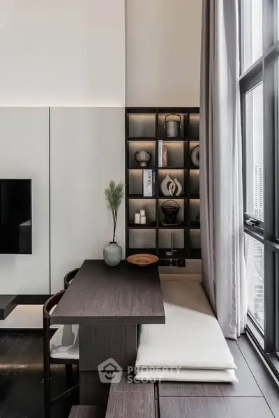 Modern living room with sleek design, large windows, and stylish shelving.