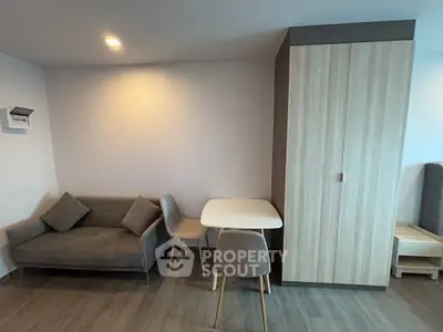 Modern living room with cozy sofa and dining area in stylish apartment.