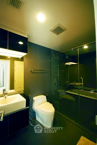 Modern bathroom with sleek design, glass shower, and elegant fixtures in a contemporary home.