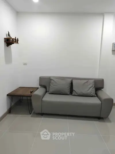 Modern living room with sleek gray sofa and minimalist decor