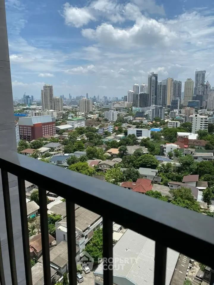 Stunning cityscape view from high-rise balcony showcasing urban skyline and greenery.
