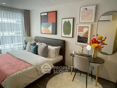 Stylish bedroom with modern decor and cozy ambiance, featuring a plush bed and elegant artwork.