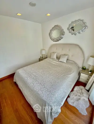 Elegant bedroom with plush bed and stylish decor in modern apartment
