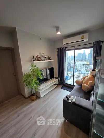 Modern living room with city view, cozy sofa, and stylish decor in a high-rise apartment.