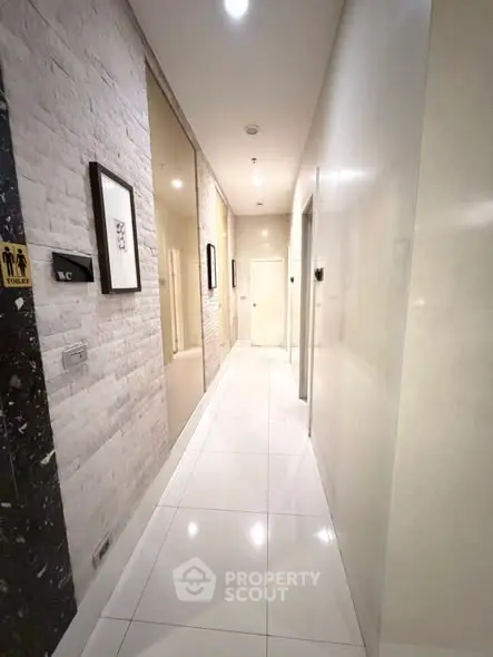 Elegant corridor with modern design and polished tiles in a residential building.