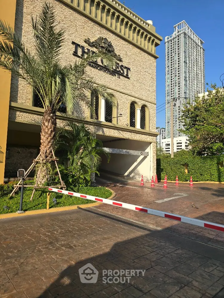 Luxurious building entrance with palm trees and modern architecture in urban setting