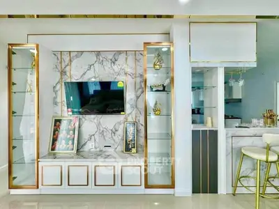Luxurious living room with marble TV wall and elegant gold accents