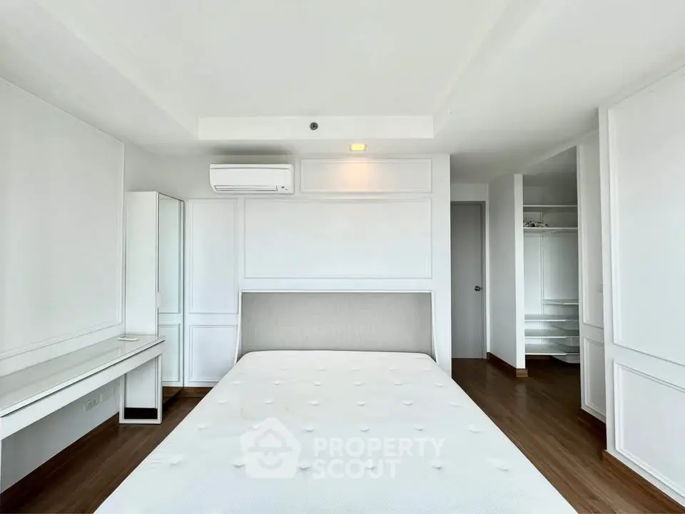 Spacious modern bedroom with minimalist design and ample natural light