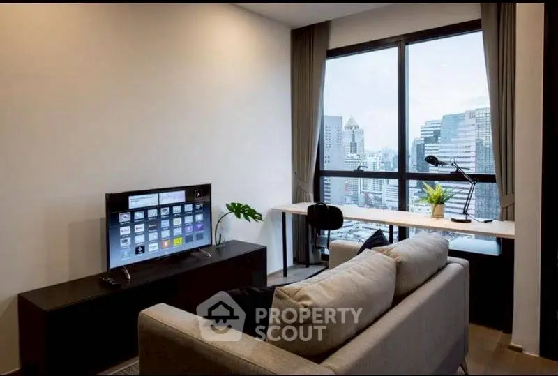 Modern living room with city view, stylish sofa, and smart TV setup.