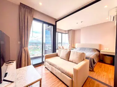 Modern apartment with spacious living room and bedroom, featuring large windows and stunning city views.