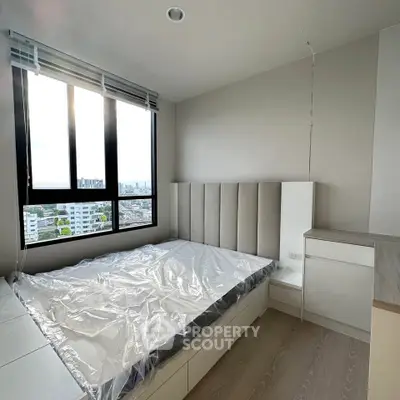 Modern bedroom with large window offering stunning city views and sleek minimalist design.