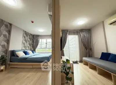 Modern bedroom with stylish decor and natural light, featuring a cozy seating area and elegant curtains.