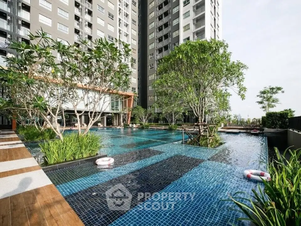 Luxurious apartment complex with stunning pool and lush greenery
