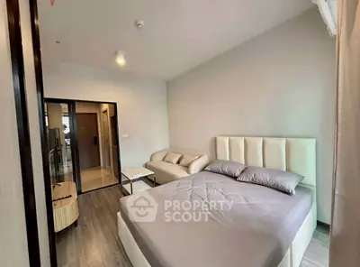Modern bedroom with stylish decor and cozy seating area