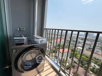 High-rise balcony with city view and modern washing machine, perfect for urban living.