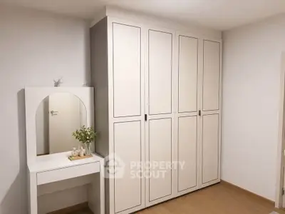 Spacious bedroom with elegant wardrobe and stylish vanity set