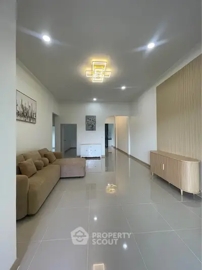 Spacious modern living room with sleek tile flooring and stylish lighting