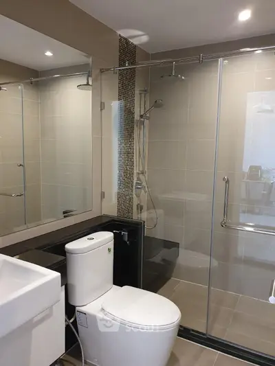 Modern bathroom with glass shower enclosure and sleek fixtures