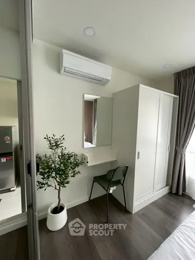 Modern bedroom with air conditioning, wardrobe, and stylish decor