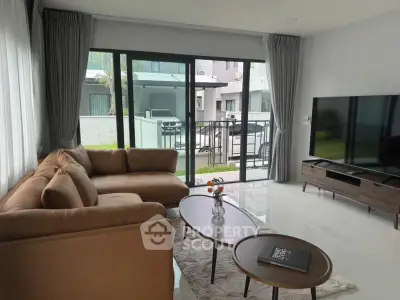 Spacious modern living room with large windows and stylish furniture