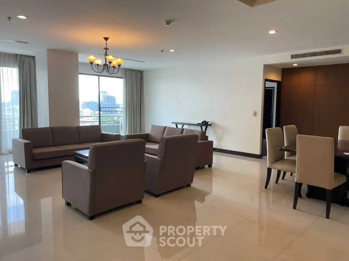 Spacious living room with elegant furniture and city view, perfect for modern urban living.