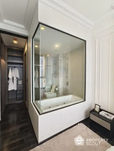 Luxurious bathroom with glass-enclosed bathtub and modern design