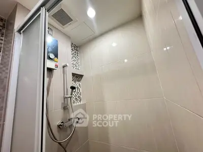 Modern bathroom shower with sleek tiles and built-in showerhead
