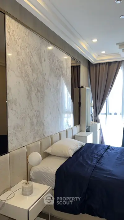 Luxurious bedroom with elegant marble accent wall and modern decor