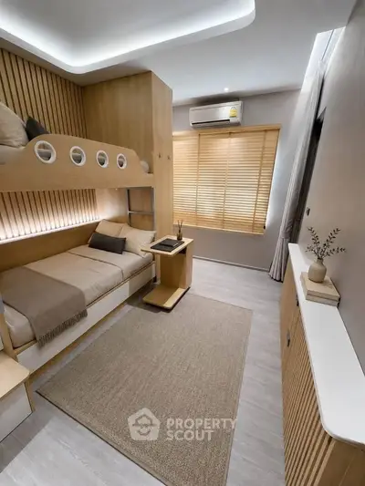 Modern bedroom with bunk bed and sleek wooden design, featuring natural light and minimalist decor.
