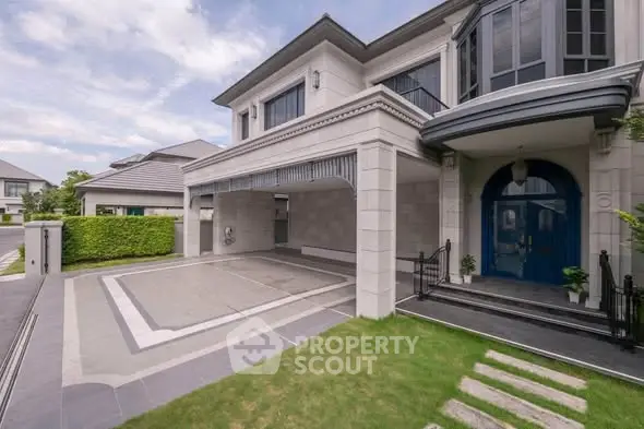 Luxurious modern house exterior with spacious driveway and elegant entrance.