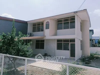 Charming two-story house with spacious driveway and modern design.