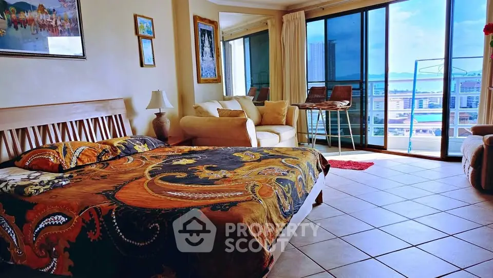 Spacious bedroom with stunning city view and elegant decor in luxury apartment.