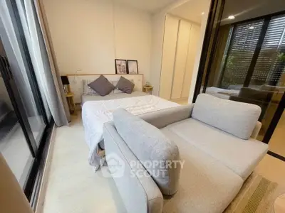 Cozy bedroom with modern decor and large windows for natural light