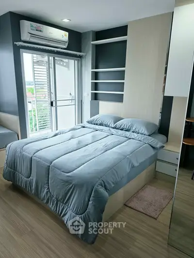 Modern bedroom with balcony access and sleek design in urban apartment